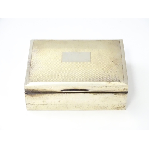 276 - A silver table top cigarette box with engine turned decoration opening to reveal a cedar lined inter... 