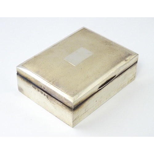 276 - A silver table top cigarette box with engine turned decoration opening to reveal a cedar lined inter... 