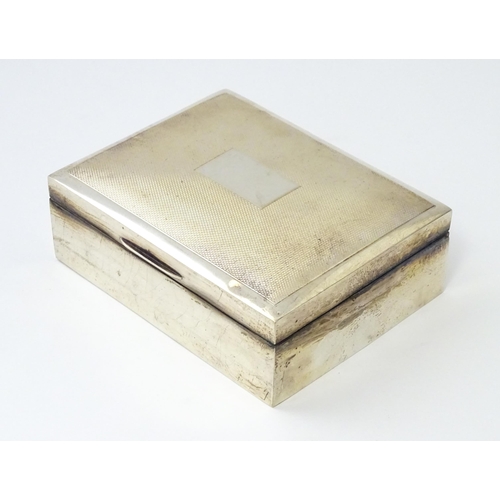 276 - A silver table top cigarette box with engine turned decoration opening to reveal a cedar lined inter... 