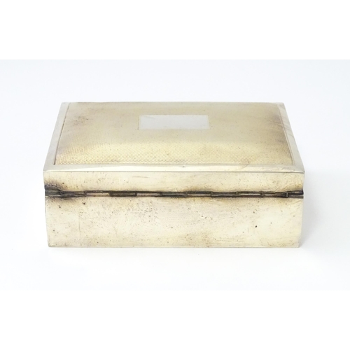 276 - A silver table top cigarette box with engine turned decoration opening to reveal a cedar lined inter... 