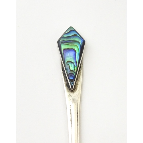 289 - A silver butter knife with abalone / paua detail to handle. Marked STG SIL.  Approx. 5 3/4