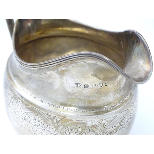 292 - A George III silver milk jug with bright cut decoration Hallmarked London 1803 Maker Alexander Field... 