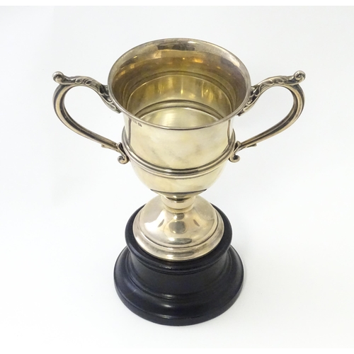 322 - A twin handled pedestal trophy cup on socle stand. The cup engraved No 15 Company Stone & District G... 