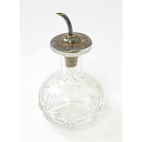 331 - A cut glass oil bottle with silver lid and spout hallmarked Birmingham 1917 maker John Grinsell & So... 