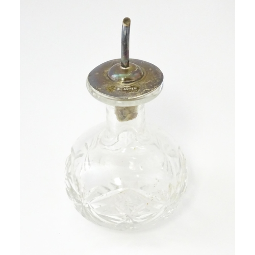 331 - A cut glass oil bottle with silver lid and spout hallmarked Birmingham 1917 maker John Grinsell & So... 