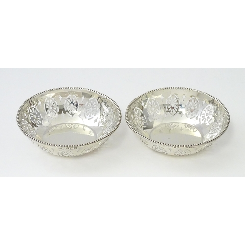 348 - A pair of silver bon bon dishes with pierced decoration, hallmarked Birmingham 1942, maker Levi & Sa... 