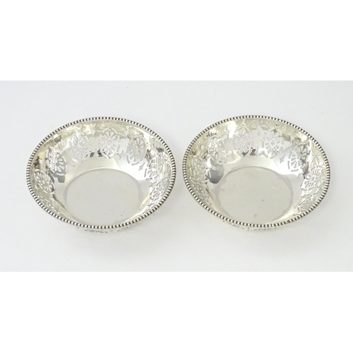 348 - A pair of silver bon bon dishes with pierced decoration, hallmarked Birmingham 1942, maker Levi & Sa... 