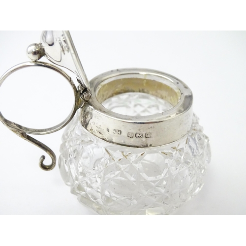 350 - A cut glass mustard pot with silver mounts and handle together with a silver mustard spoon. Both hal... 