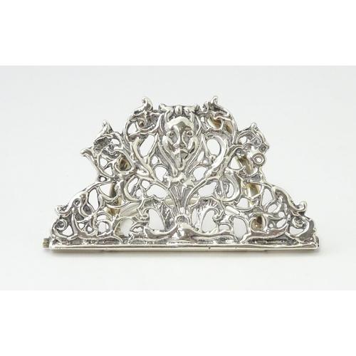 353 - A Victorian silver menu holder /  table place card holder with scrolling detail. Hallmarked Chester ... 