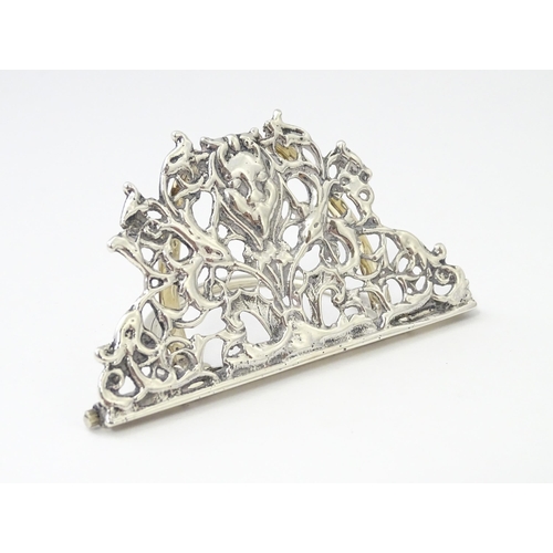 353 - A Victorian silver menu holder /  table place card holder with scrolling detail. Hallmarked Chester ... 