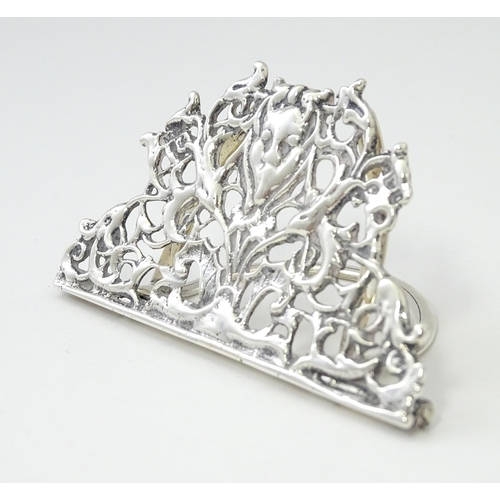 353 - A Victorian silver menu holder /  table place card holder with scrolling detail. Hallmarked Chester ... 