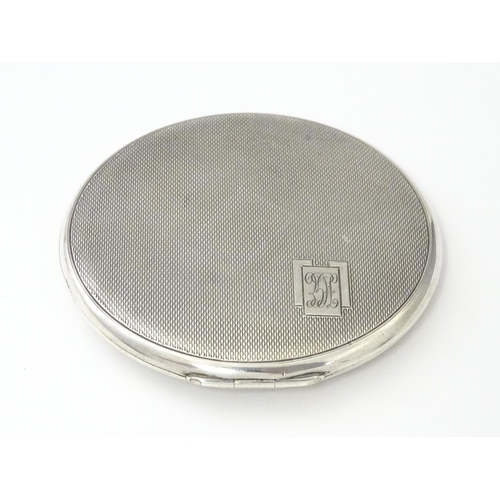 360 - An Art Deco silver compact of engine turned decoration hallmarked Birmingham 1939, maker William Suc... 