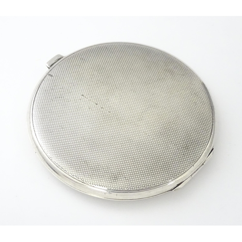 360 - An Art Deco silver compact of engine turned decoration hallmarked Birmingham 1939, maker William Suc... 