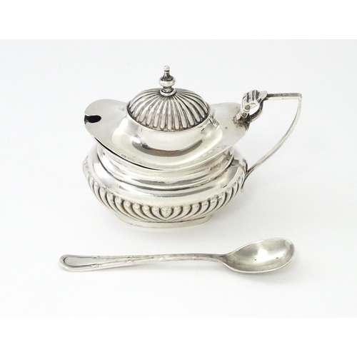 367 - A silver mustard pot with fluted decoration hallmarked Birmingham 1906, maker Robert Pringle & Sons.... 