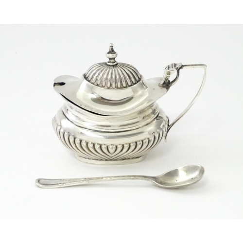 367 - A silver mustard pot with fluted decoration hallmarked Birmingham 1906, maker Robert Pringle & Sons.... 