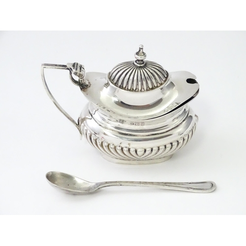 367 - A silver mustard pot with fluted decoration hallmarked Birmingham 1906, maker Robert Pringle & Sons.... 