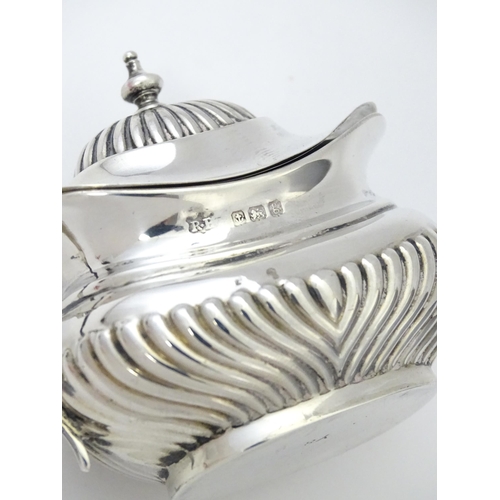 367 - A silver mustard pot with fluted decoration hallmarked Birmingham 1906, maker Robert Pringle & Sons.... 