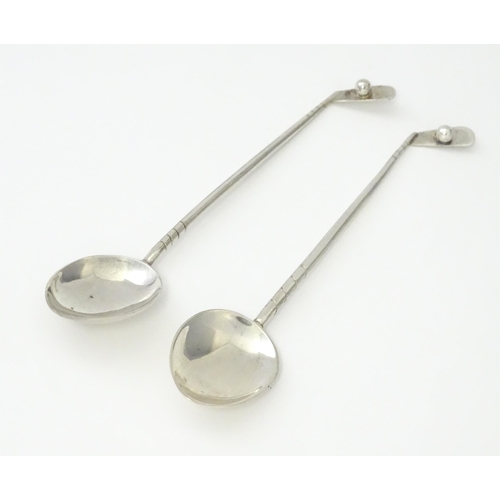 369 - Two silver coffee spoons, the handles formed as golf clubs and balls, hallmarked Birmingham 1933, ma... 