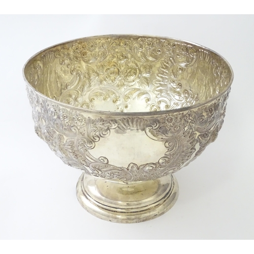 448 - A Victorian silver large pedestal bowl / rose bowl with embossed floral and acanthus scroll detail, ... 