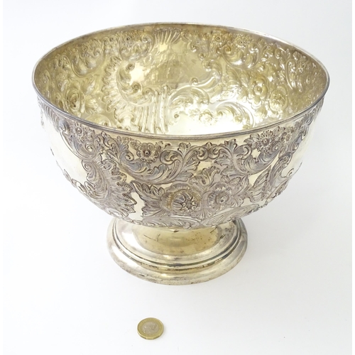 448 - A Victorian silver large pedestal bowl / rose bowl with embossed floral and acanthus scroll detail, ... 