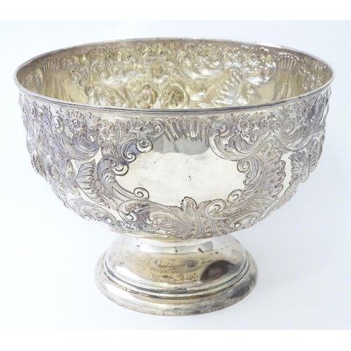 448 - A Victorian silver large pedestal bowl / rose bowl with embossed floral and acanthus scroll detail, ... 