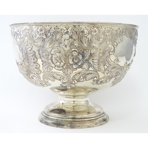 448 - A Victorian silver large pedestal bowl / rose bowl with embossed floral and acanthus scroll detail, ... 