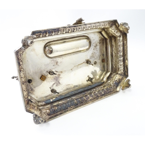 454 - A silver desk standish with Classical muse flanked by two urn formed inkwells and recessed pen well,... 