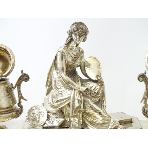 454 - A silver desk standish with Classical muse flanked by two urn formed inkwells and recessed pen well,... 