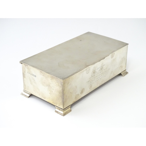 474 - An Art Deco silver table top cigarette box with engine turned decoration and inscription to front, o... 