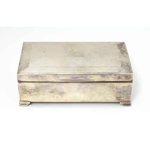 478 - A silver table top cigarette box with engine turned decoration opening to reveal a cedar lined inter... 