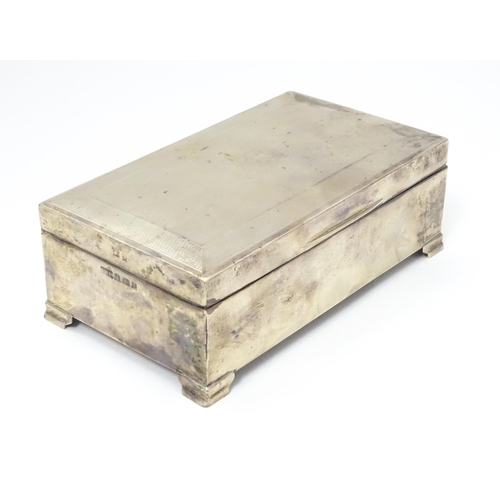 478 - A silver table top cigarette box with engine turned decoration opening to reveal a cedar lined inter... 