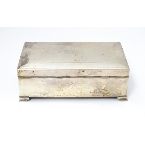 478 - A silver table top cigarette box with engine turned decoration opening to reveal a cedar lined inter... 