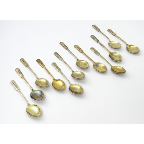 488 - A cased set of twelve silver gilt teaspoons with black enamel detail to reverse of handles and bowls... 