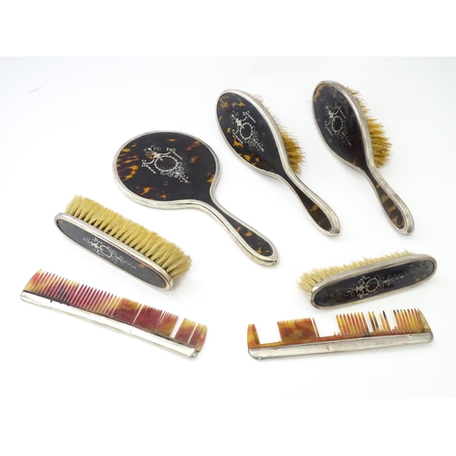 494 - A cased silver and tortoiseshell dressing table set with pique work detail comprising hand mirror an... 