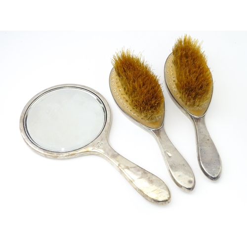 494 - A cased silver and tortoiseshell dressing table set with pique work detail comprising hand mirror an... 