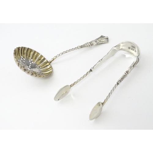 500 - A cased set of six silver teaspoons with tongs and sifter spoon en suite, hallmarked Birmingham 1904... 