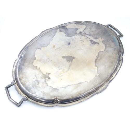 458 - An Art Deco silver twin handle tray of oval form, hallmarked Sheffield 1936, maker Mappin & Webb Ltd... 