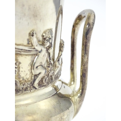 459 - A silver twin handled vase of campana urn form decorated with classical scenes depicting putti with ... 