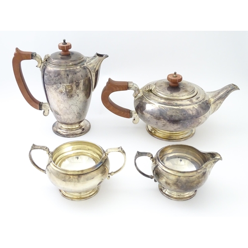 460 - An Art Deco four piece silver tea set comprising teapot, cream jug, sugar bowl and hot water / coffe... 