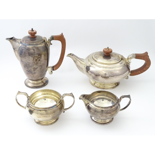 460 - An Art Deco four piece silver tea set comprising teapot, cream jug, sugar bowl and hot water / coffe... 