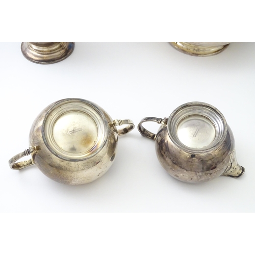 460 - An Art Deco four piece silver tea set comprising teapot, cream jug, sugar bowl and hot water / coffe... 