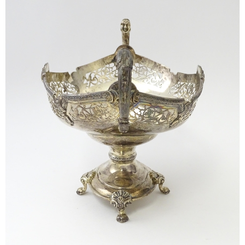 464 - A silver twin handled pedestal bowl with fretwork decoration and figural detail to handles, standing... 