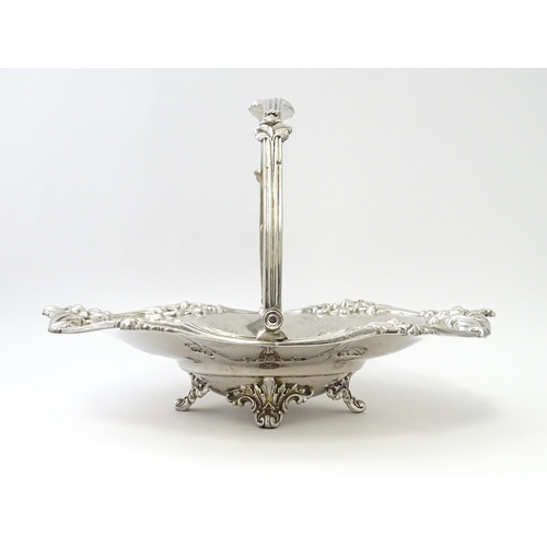 467 - A Victorian silver cake basket with floral and acanthus detail, a swing handle and later inscription... 