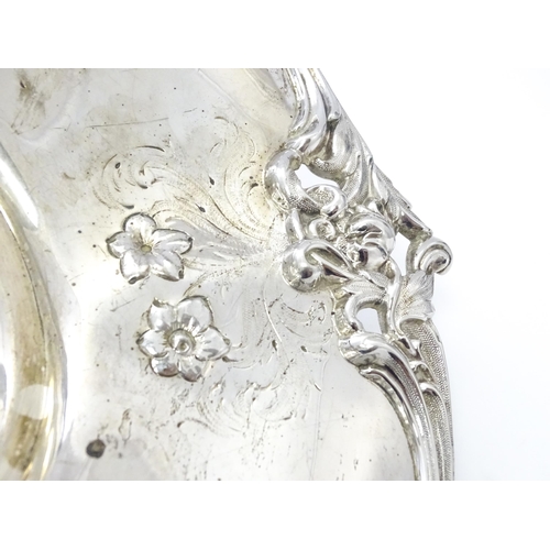 467 - A Victorian silver cake basket with floral and acanthus detail, a swing handle and later inscription... 