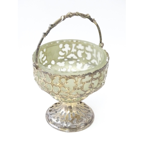 468 - A Victorian silver sugar basket of pedestal form with pierced decoration, swing handle and glass lin... 