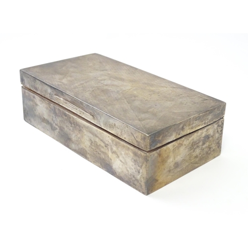 469 - An Art Deco silver table top cigarette box with engine turned decoration opening to reveal a cedar l... 