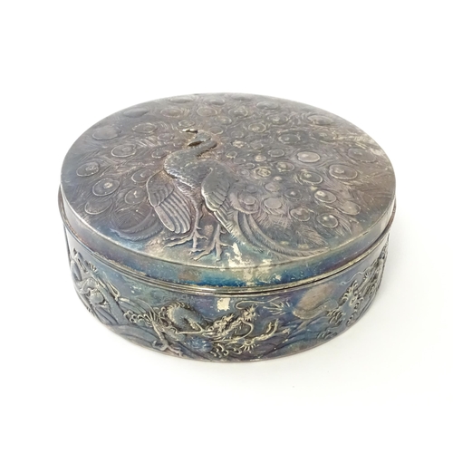 470 - An Art Nouveau silver plate powder box with relief peacock decoration to lid, the body with scrollin... 