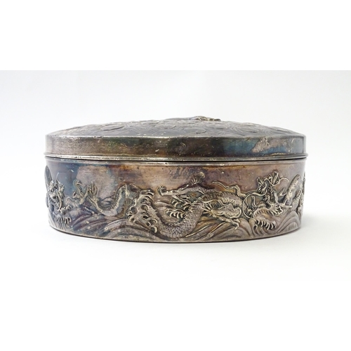 470 - An Art Nouveau silver plate powder box with relief peacock decoration to lid, the body with scrollin... 