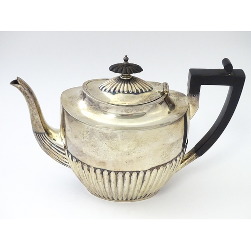 477 - A Victorian silver three piece tea set comprising teapot, cream jug and twin handled sugar bowl with... 