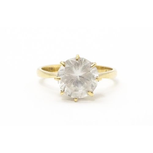 565 - A 9ct gold ring set with a white stone solitaire. Ring size approx. O